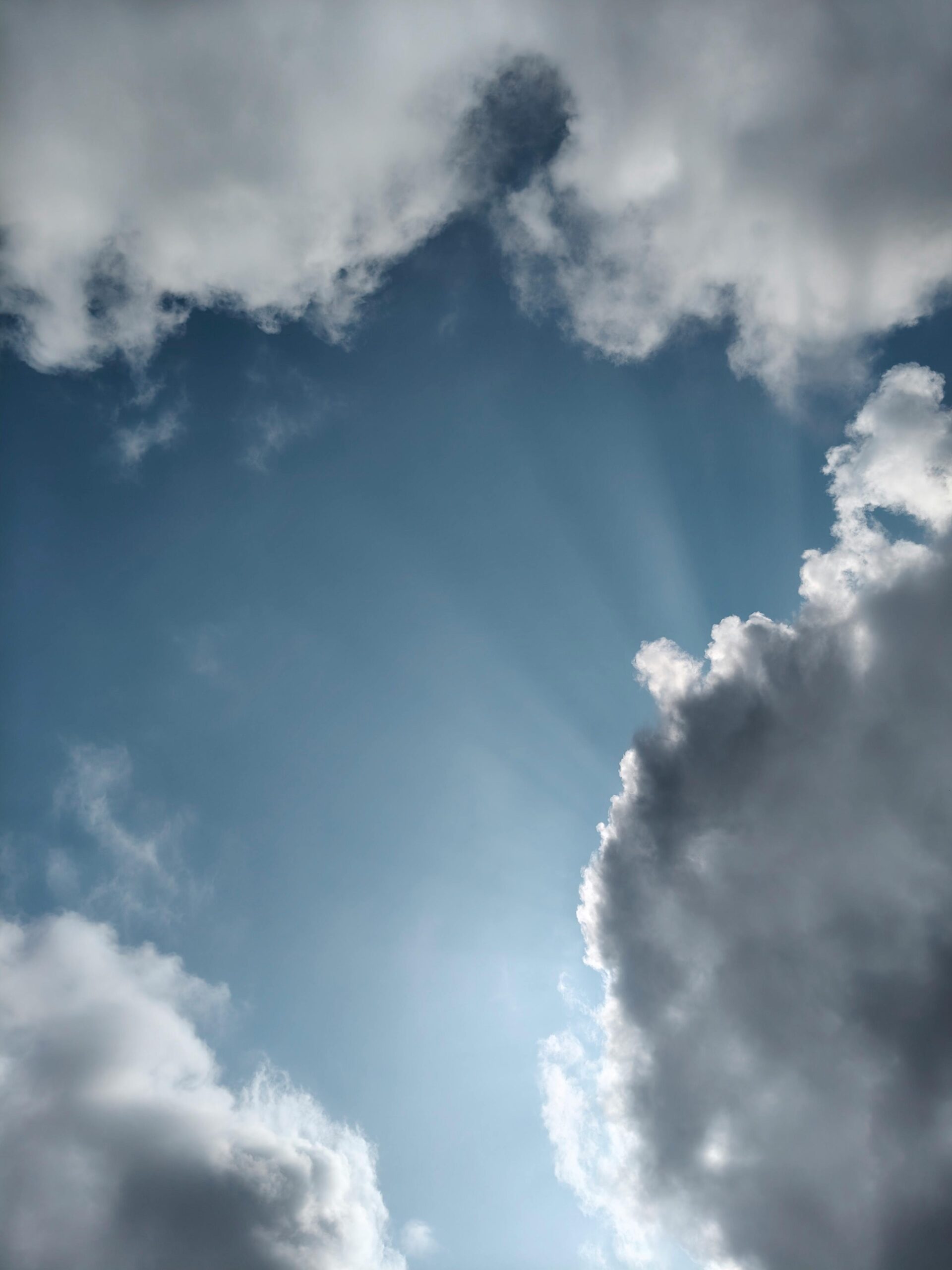 A captivating afternoon sky with sunlight rays shining through clouds in Silchar, Assam.