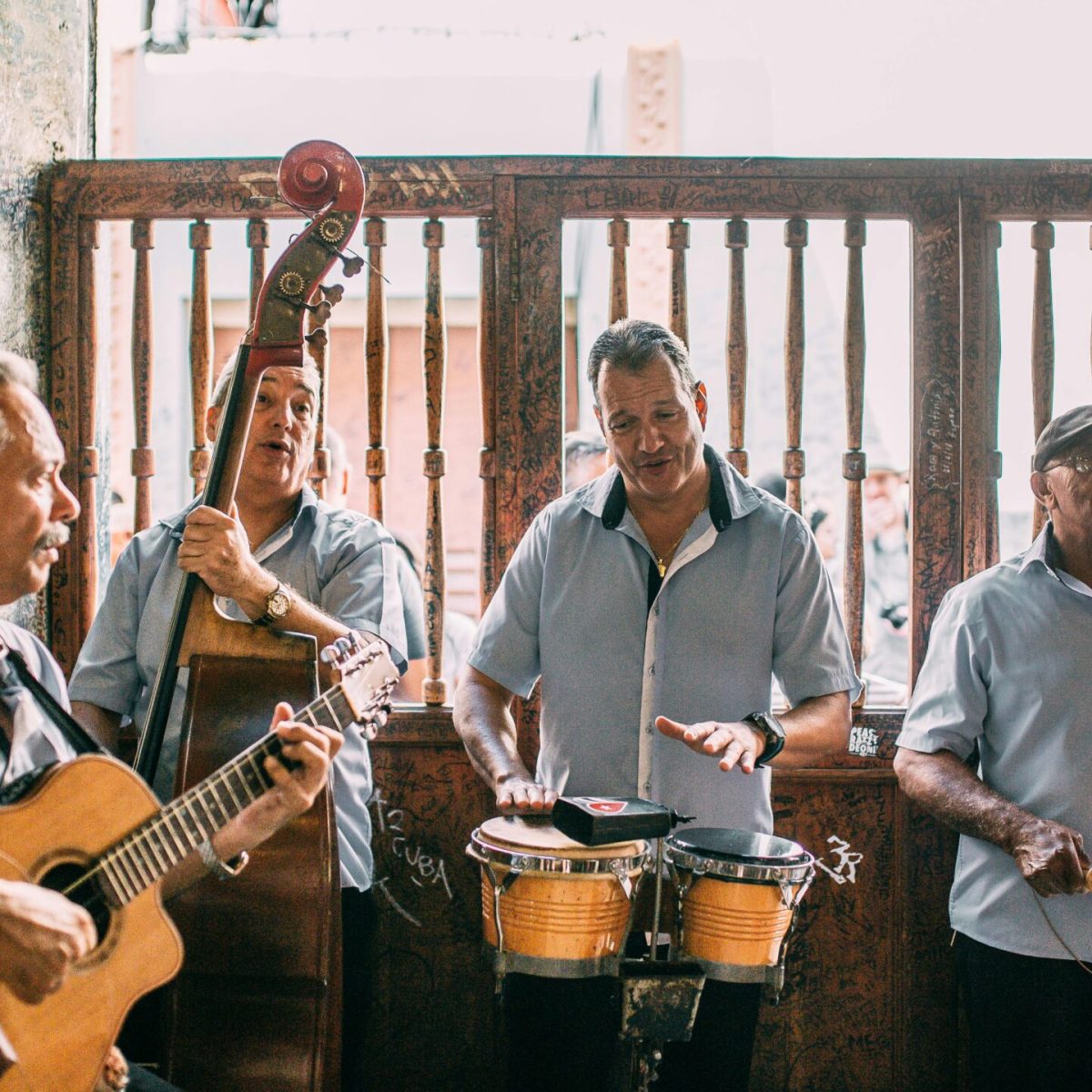 A lively band of musicians performing indoors with various instruments, creating a vibrant atmosphere.